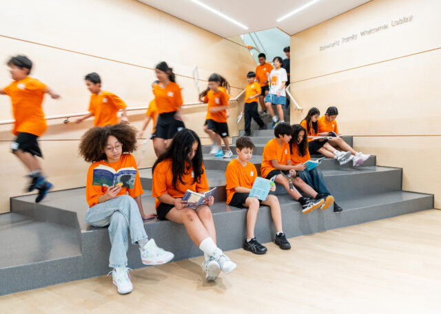 citysquash students sitting on the lobby steps and running down the stairs